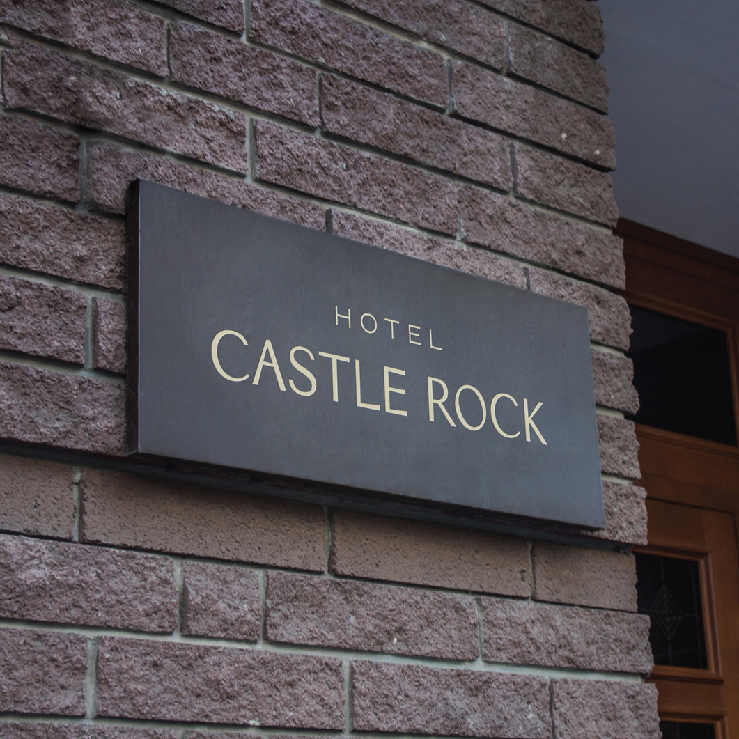 Brick wall with Hotel Castle Rock sign